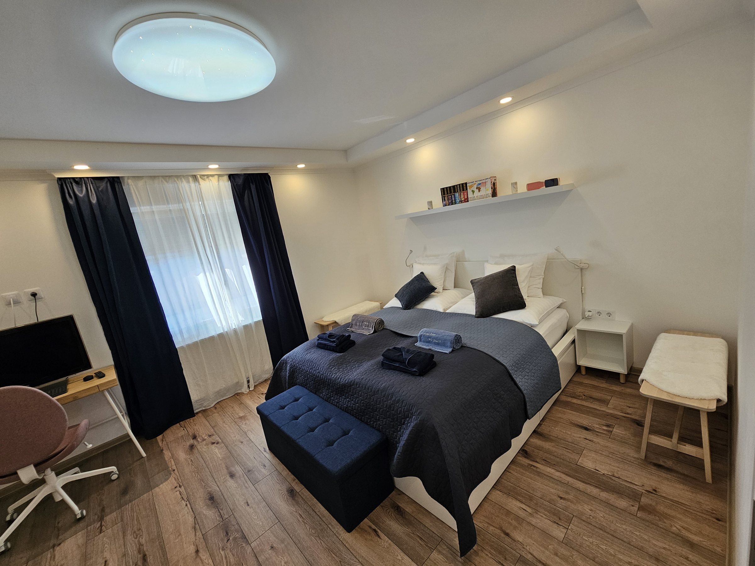 Calm bedroom with king-size bed and dedicated workspace